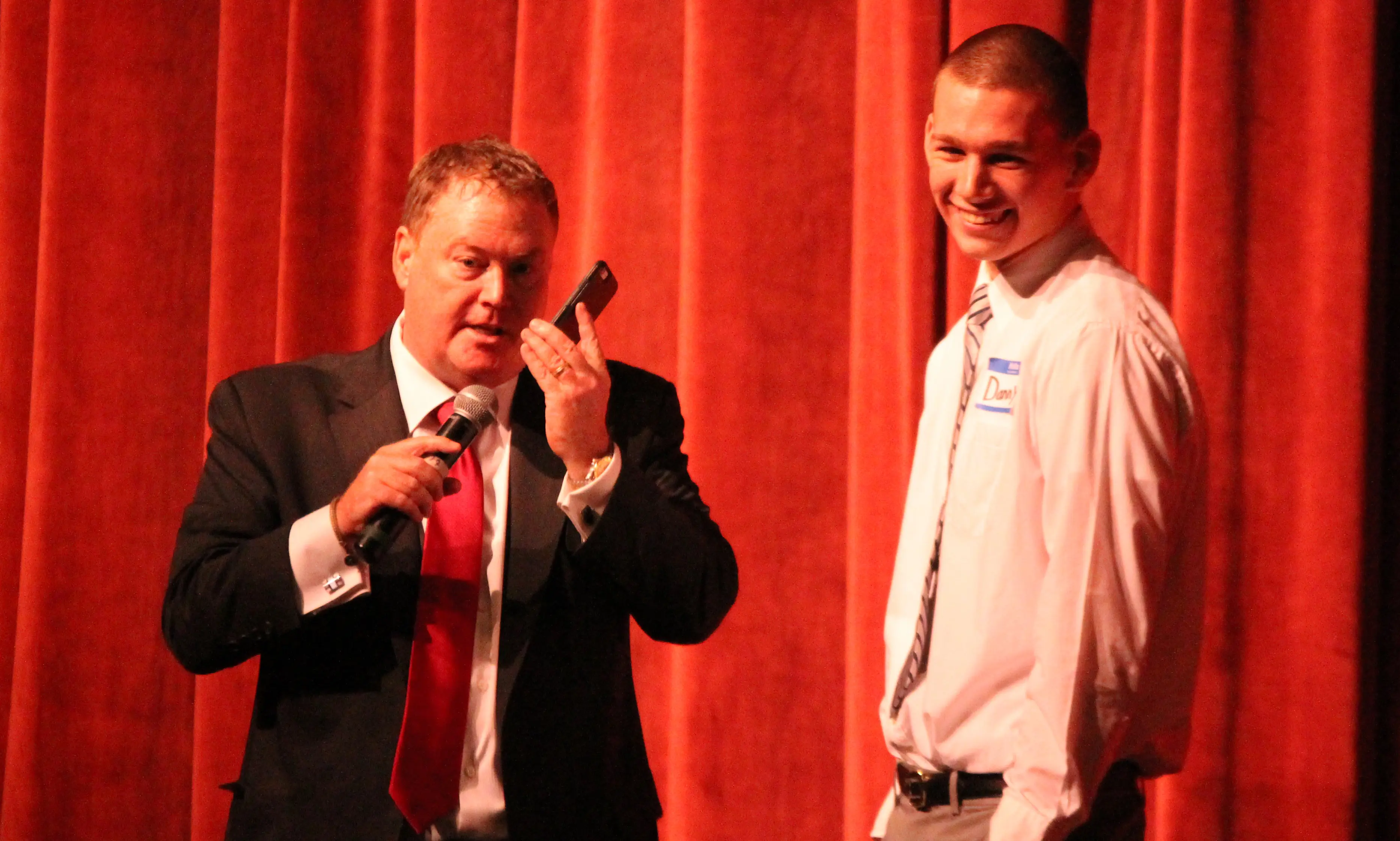 Motivational speaker Ed Gerety talks on Taunton's Danny Keogh's phone during his presentation on Wednesday. (Ryan Lanigan/HockomockSports.com)
