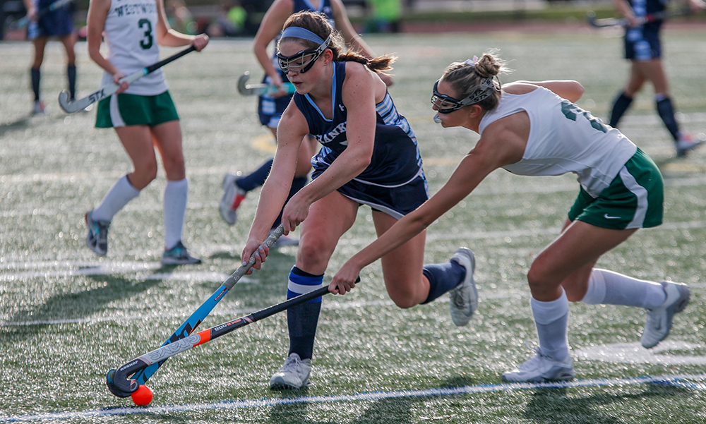Franklin’s Cassi Ronan (left) carries possession past a Westwood defender in the first half. (Ryan Lanigan/HockomockSports.com)
