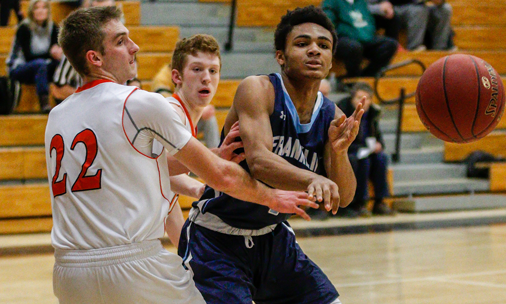 Franklin’s Jalen Samuels (right) makes a pass against Oliver Ames in the second half. (Ryan Lanigan/HockomockSports.com)